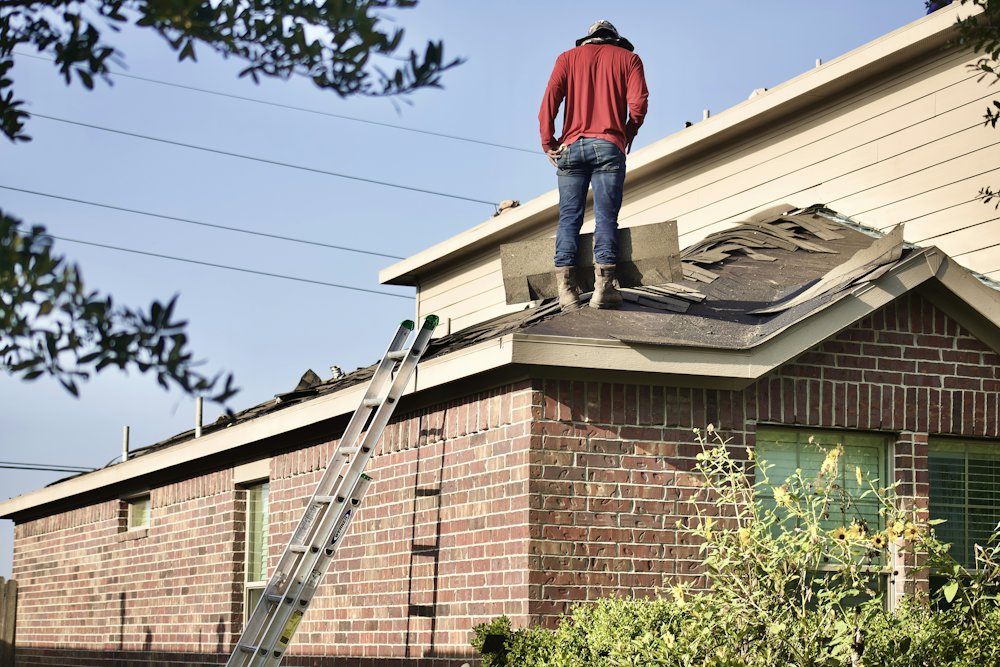 Roofer working on a two-story home