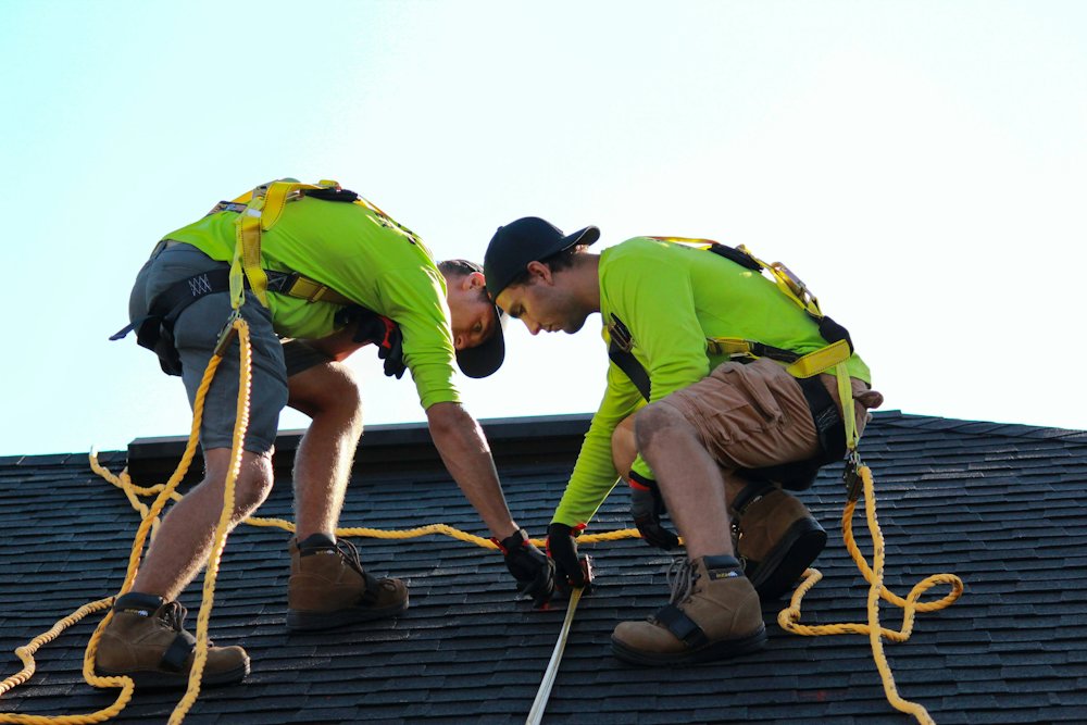 Roofing crew installing a new shingle roof